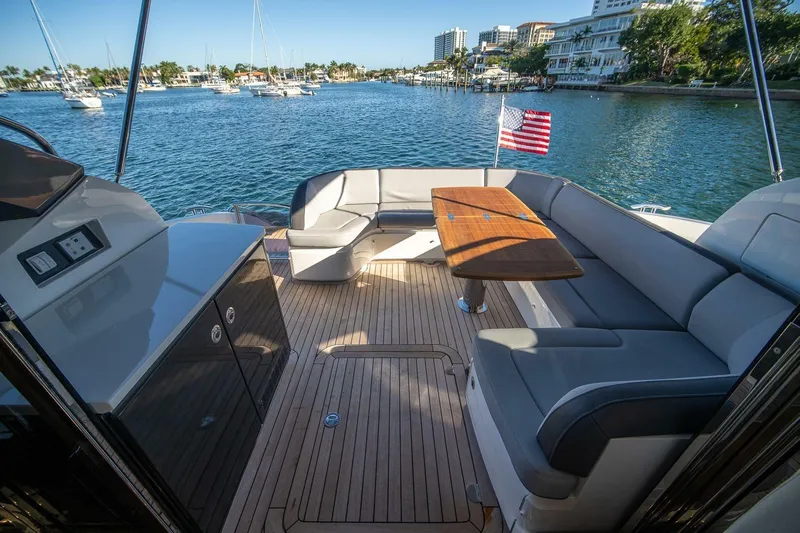 Sea-licious Yacht Photos Pics Luxurious 2016 Princess V48 yacht interior with seating, table, and scenic waterfront view.
