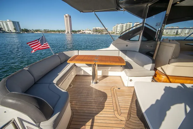 Sea-licious Yacht Photos Pics Luxurious 2016 Princess V48 yacht deck with seating, table, and American flag.