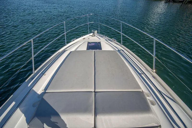 Sea-licious Yacht Photos Pics 2016 Princess V48 yacht bow with sunpad on calm water.