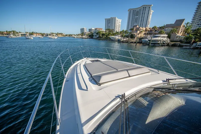 Sea-licious Yacht Photos Pics 2016 Princess V48 yacht cruising in a scenic waterfront cityscape.
