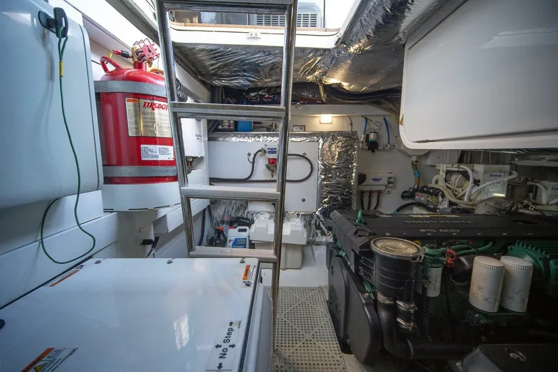 Sea-licious Yacht Photos Pics Engine room of 2016 Princess V48 yacht with fire extinguisher and mechanical equipment.