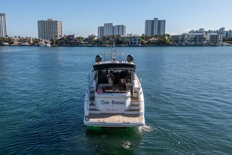 Sea-licious Yacht Photos Pics 2016 Princess V48 yacht on water with city skyline in background.