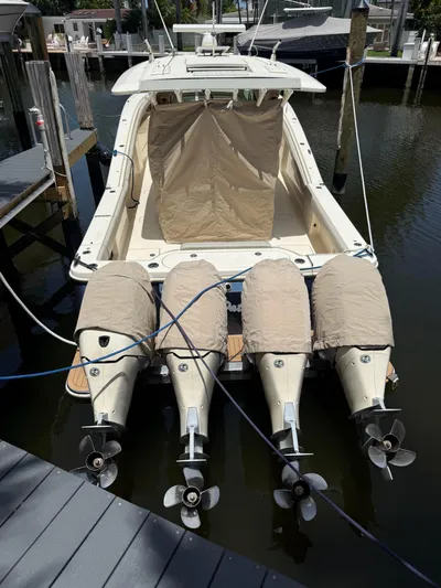 Reel Patience Yacht Photos Pics 2019 Scout 420 LXF boat with four covered outboard motors docked in a marina.