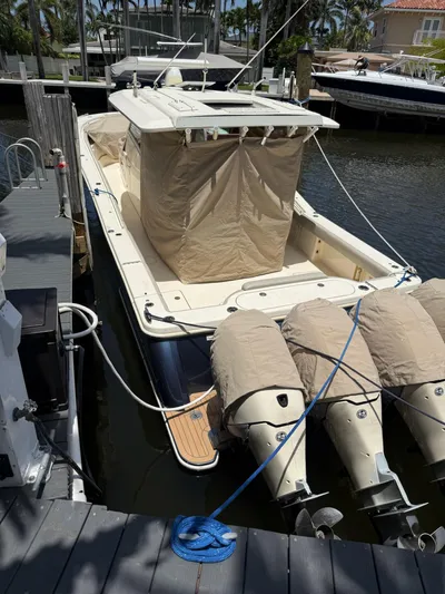 Reel Patience Yacht Photos Pics 2019 Scout 420 LXF boat docked with covered engines and beige canopy.