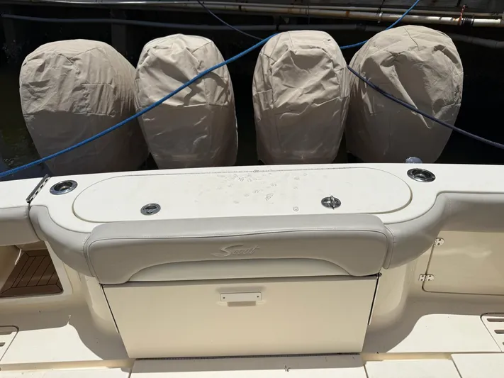Reel Patience Yacht Photos Pics 2019 Scout 420 LXF boat with covered engines and sleek seating area.
