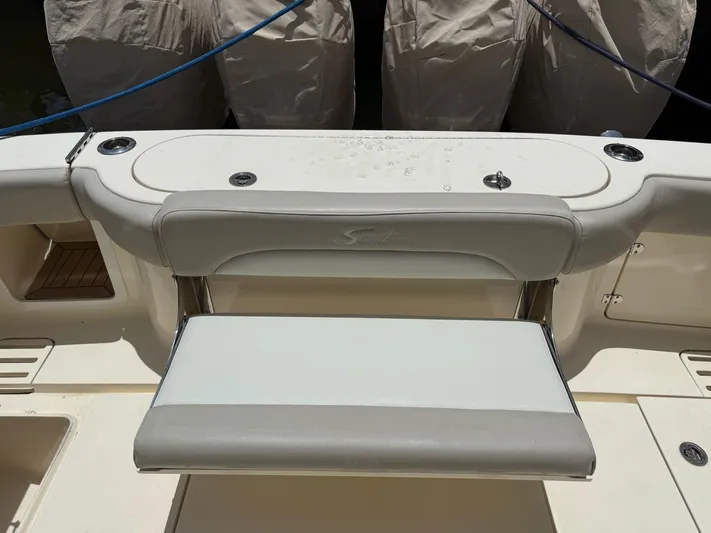 Reel Patience Yacht Photos Pics 2019 Scout 420 LXF boat seating area with covered engines in the background.