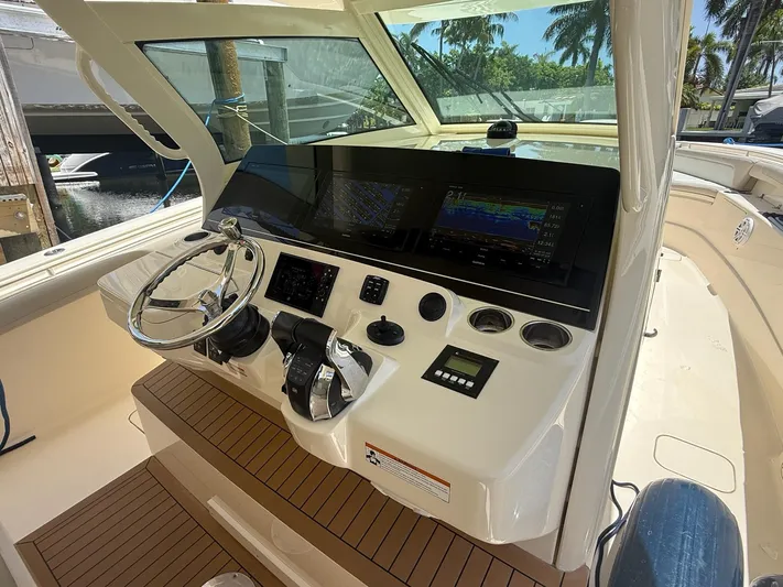 Reel Patience Yacht Photos Pics Helm of 2019 Scout 420 LXF boat with advanced navigation controls and steering wheel.