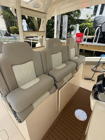 Reel Patience Yacht Photos Pics Luxurious seating on a 2019 Scout 420 LXF boat, featuring elegant beige upholstery.