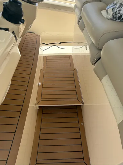 Reel Patience Yacht Photos Pics 2019 Scout 420 LXF boat interior with teak flooring and cushioned seating.