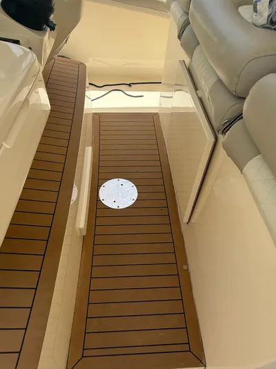 Reel Patience Yacht Photos Pics 2019 Scout 420 LXF boat interior with teak flooring and cushioned seating.