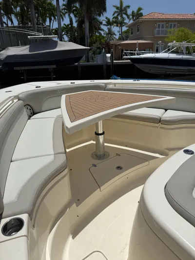 Reel Patience Yacht Photos Pics 2019 Scout 420 LXF boat interior with seating and table, docked near waterfront homes.