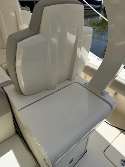 Reel Patience Yacht Photos Pics 2019 Scout 420 LXF boat seat and console detail, featuring sleek white design.