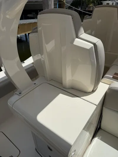 Reel Patience Yacht Photos Pics 2019 Scout 420 LXF boat interior seating, featuring sleek white upholstery and modern design.