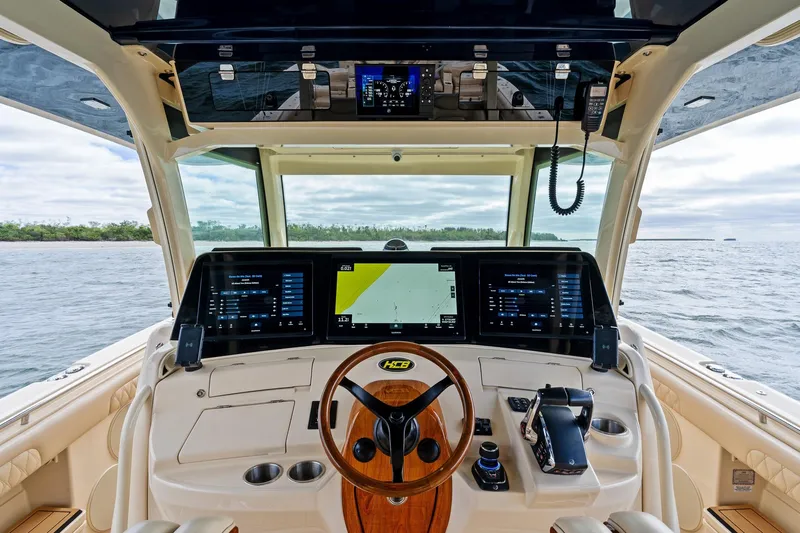 Off Line Yacht Photos Pics 2023 HCB 53 Suenos RXV helm with advanced navigation displays and luxurious interior.
