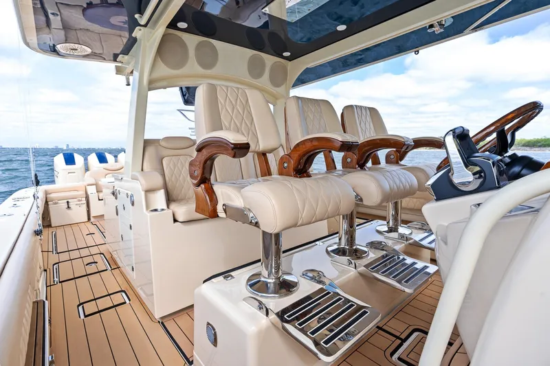 Off Line Yacht Photos Pics Luxurious interior of 2023 HCB 53 Suenos RXV boat with plush seating and elegant design.