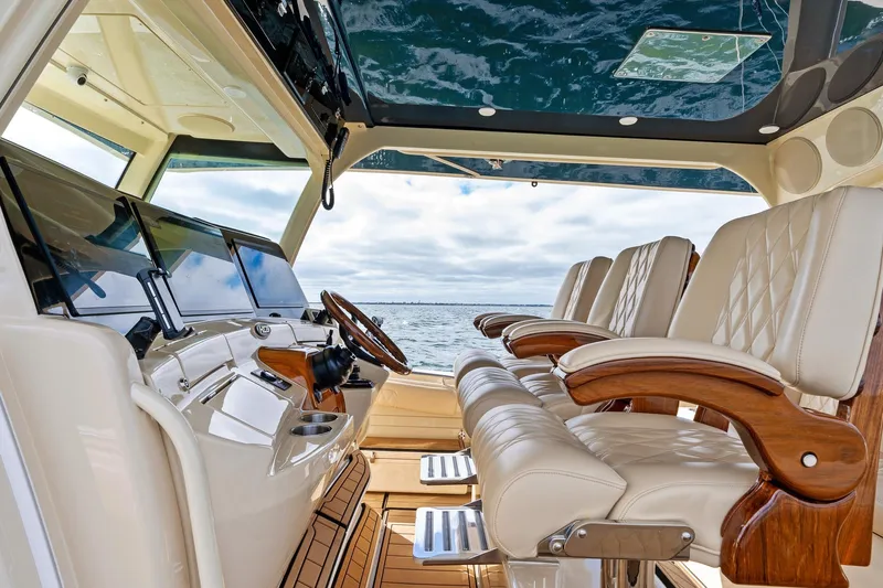 Off Line Yacht Photos Pics 2023 HCB 53 Suenos RXV luxury boat interior with plush seating and advanced controls.
