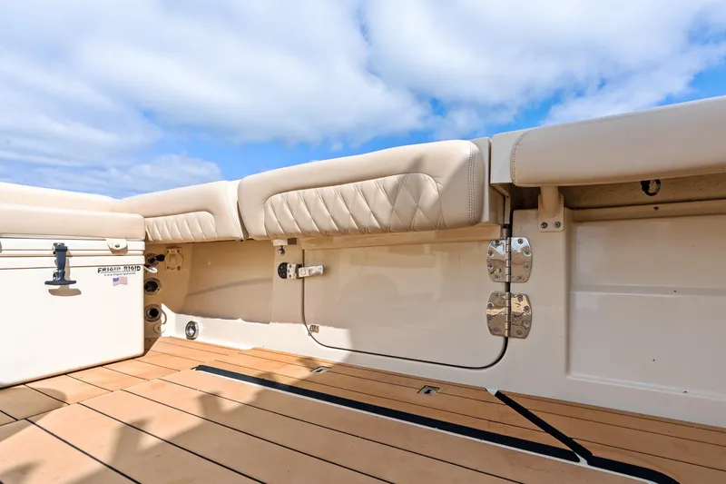 Off Line Yacht Photos Pics 2023 HCB 53 Suenos RXV boat interior with cushioned seating and wooden deck.