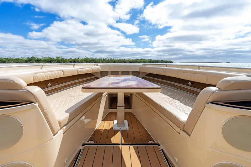 Off Line Yacht Photos Pics Luxurious interior of 2023 HCB 53 Suenos RXV boat with elegant seating and table.