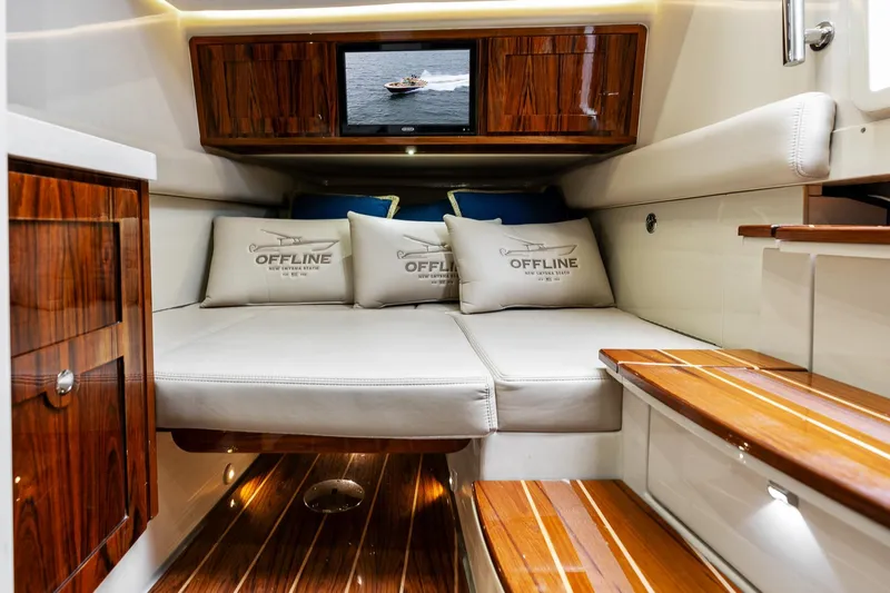 Off Line Yacht Photos Pics Interior of 2023 HCB 53 Suenos RXV yacht with luxurious seating and wood accents.