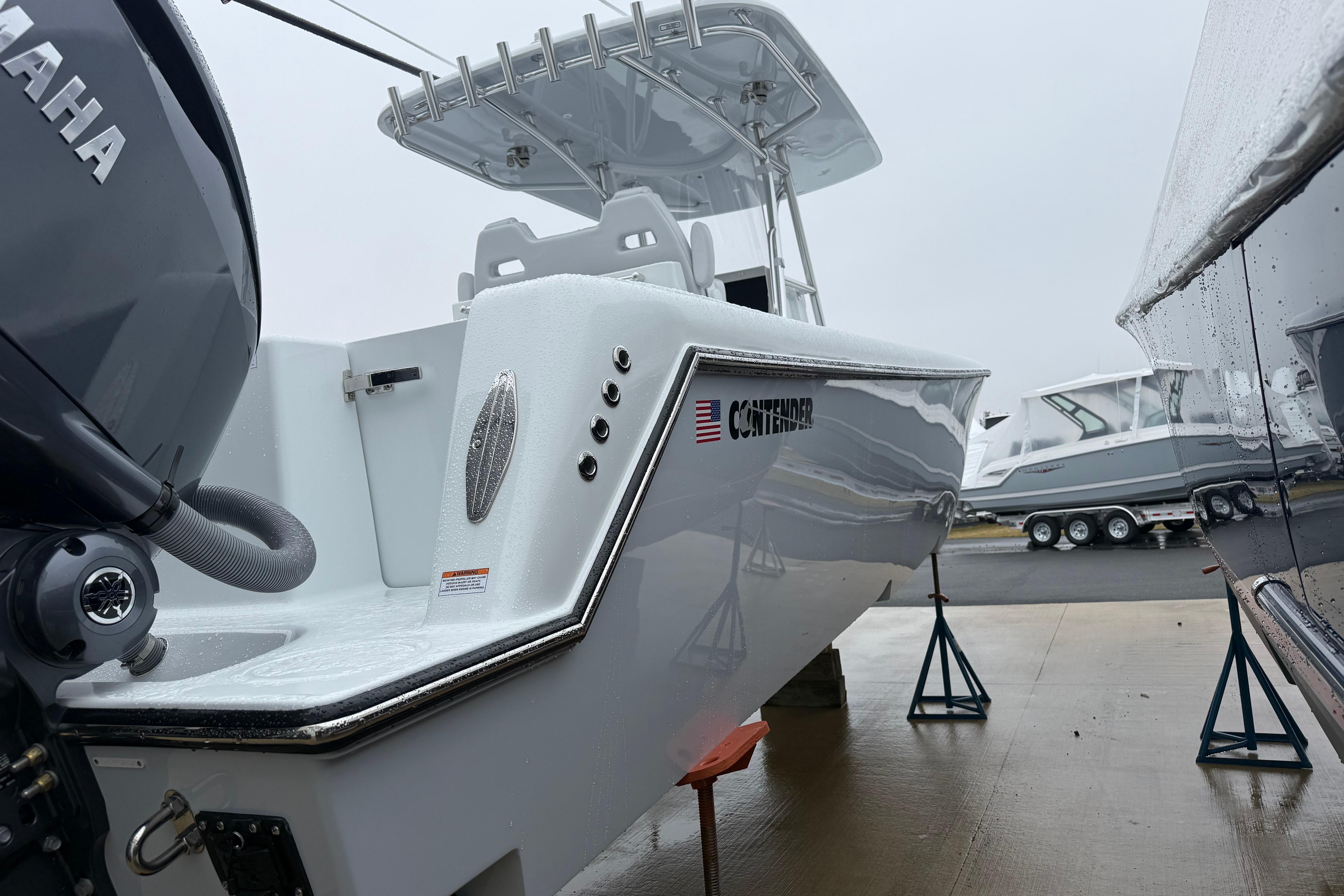 2026 Contender 35 ST boat on stands, featuring sleek design and Yamaha engine.