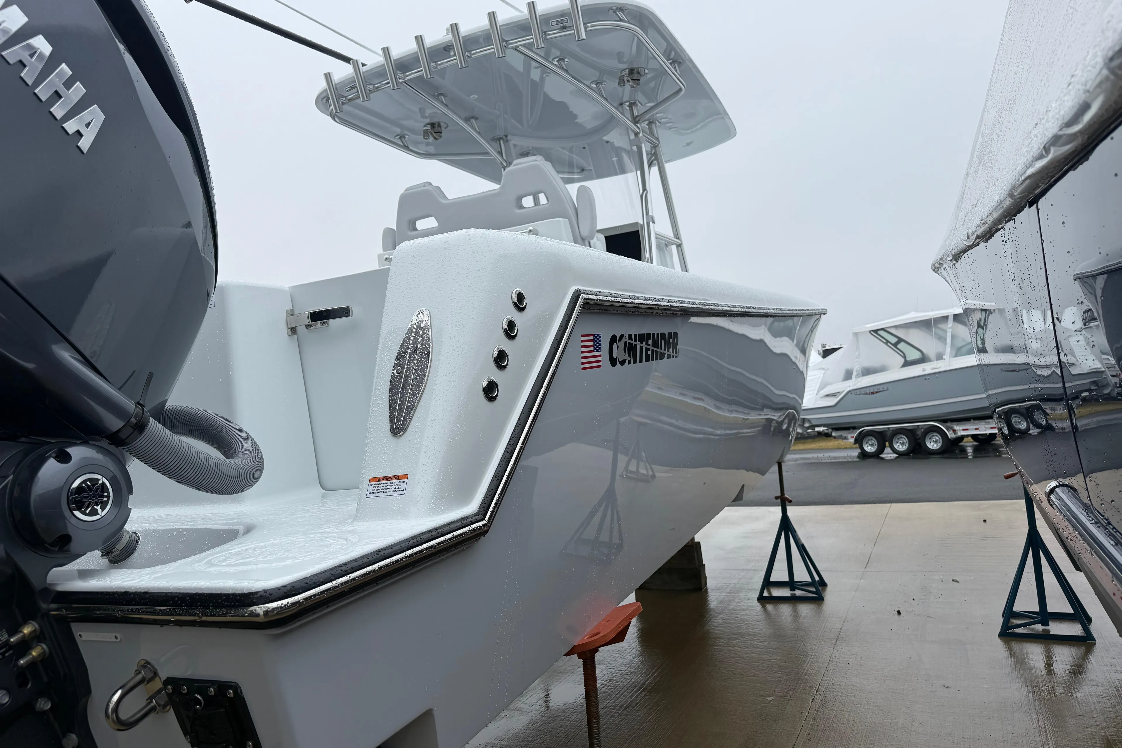 2026 Contender 35 ST boat on stands, featuring sleek design and Yamaha engine.