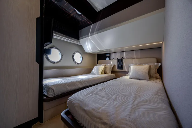  Yacht Photos Pics Luxurious twin cabin interior on 2019 Azimut 66 FLY yacht with porthole windows.