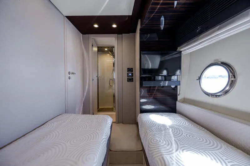  Yacht Photos Pics Luxurious cabin interior of 2019 Azimut 66 FLY yacht with twin beds and porthole window.