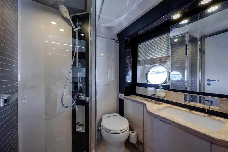  Yacht Photos Pics Luxurious bathroom in 2019 Azimut 66 FLY yacht with modern fixtures and porthole window.