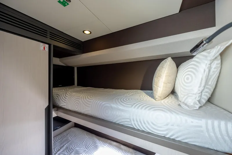  Yacht Photos Pics Bunk beds in the 2019 Azimut 66 FLY yacht cabin, featuring modern design and cozy bedding.