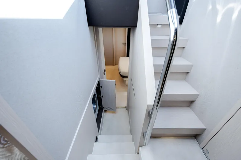  Yacht Photos Pics Staircase and hallway inside 2019 Azimut 66 FLY yacht, featuring modern design and sleek finishes.