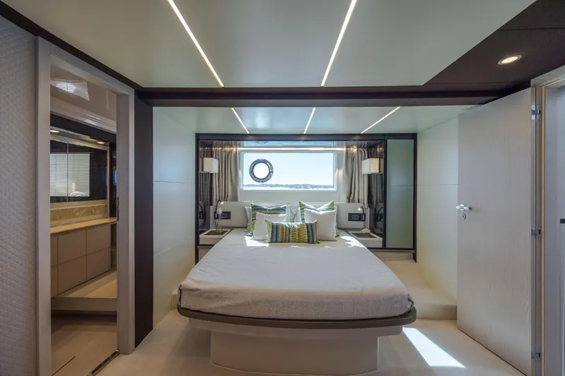  Yacht Photos Pics Luxurious bedroom interior of 2019 Azimut 66 FLY yacht with modern design and window view.