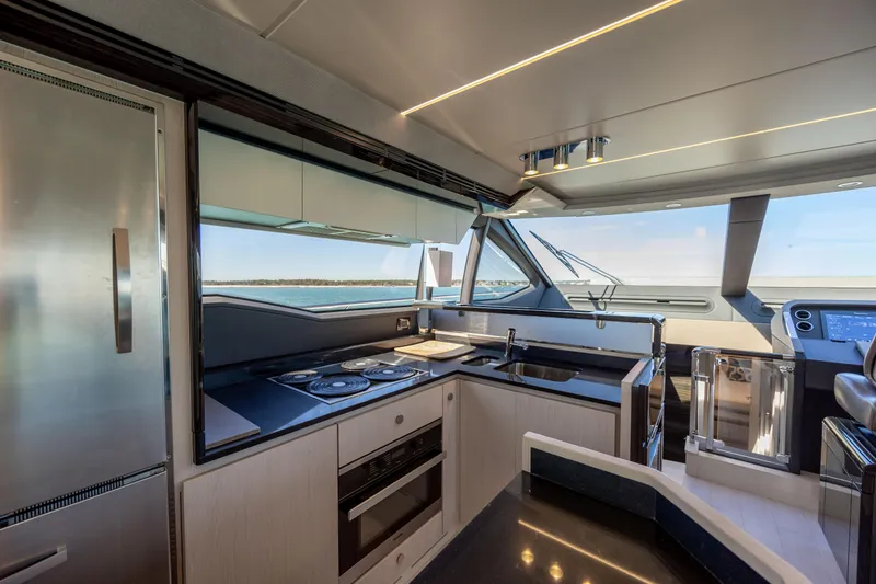  Yacht Photos Pics Luxurious kitchen interior of 2019 Azimut 66 FLY yacht with modern appliances and ocean view.
