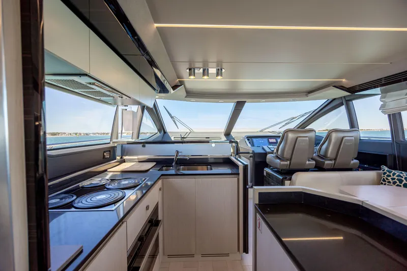  Yacht Photos Pics Luxurious interior of 2019 Azimut 66 FLY yacht with modern kitchen and helm station.