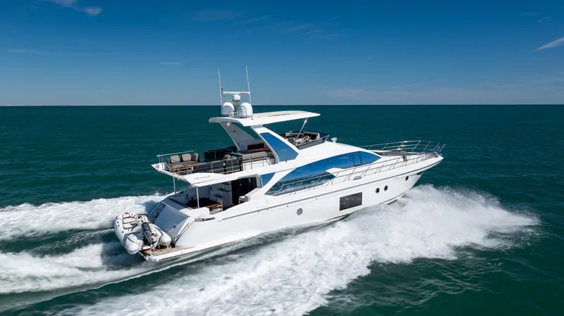  Yacht Photos Pics 2019 Azimut 66 FLY yacht cruising on open sea under clear blue sky.