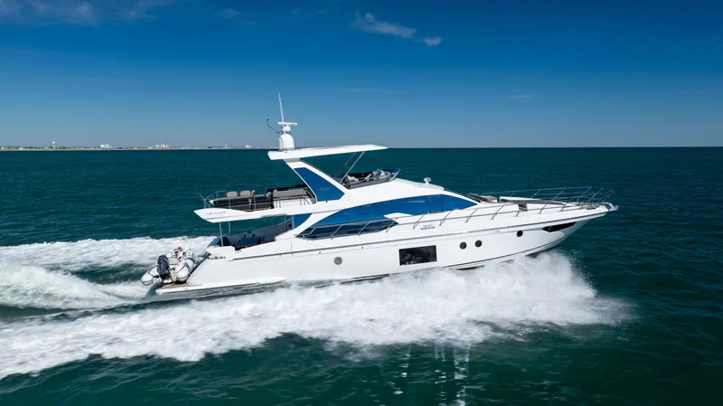  Yacht Photos Pics 2019 Azimut 66 FLY yacht cruising on open sea under clear blue sky.