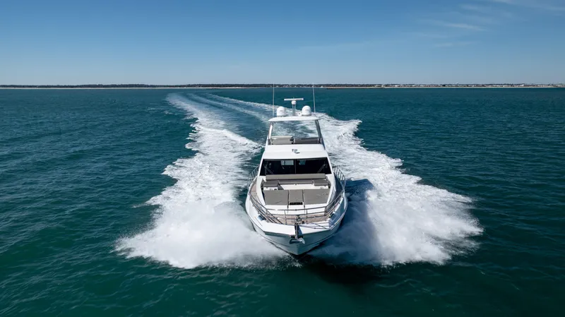  Yacht Photos Pics 2019 Azimut 66 FLY yacht cruising on open water, leaving a wake behind.