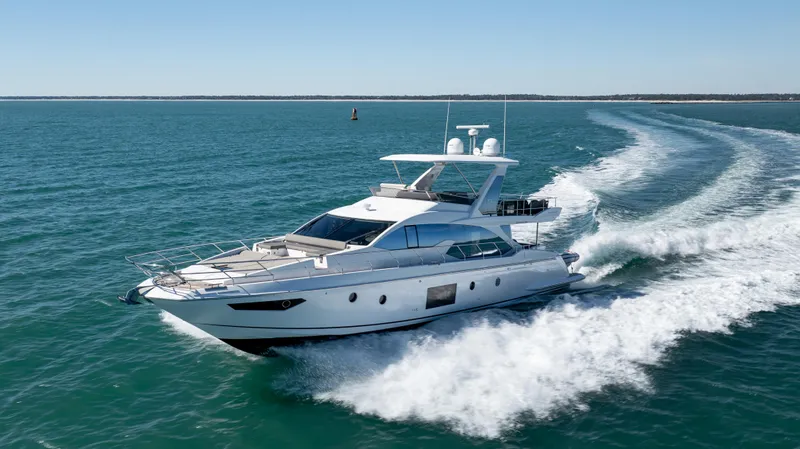  Yacht Photos Pics 2019 Azimut 66 FLY yacht cruising on open water, creating a wake.