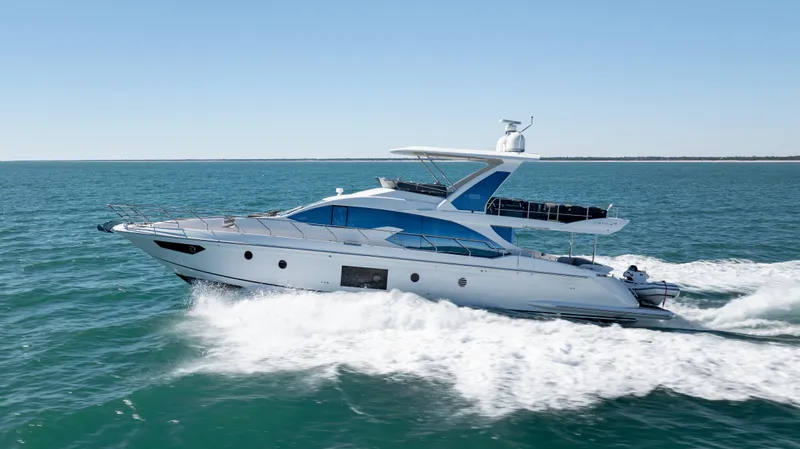  Yacht Photos Pics 2019 Azimut 66 FLY yacht cruising on open sea under clear blue sky.