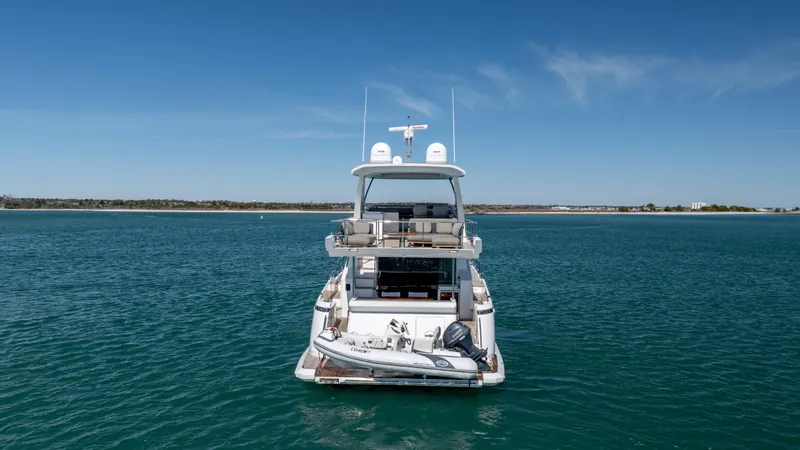  Yacht Photos Pics 2019 Azimut 66 FLY yacht on calm blue water, rear view.