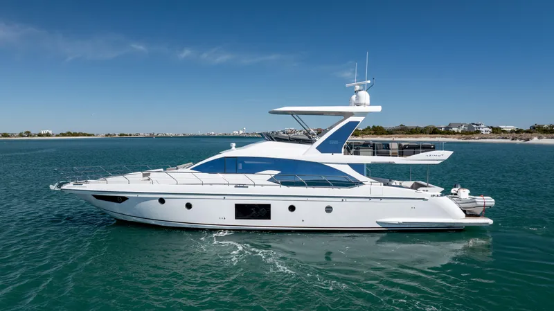  Yacht Photos Pics 2019 Azimut 66 FLY yacht cruising on clear blue water under a sunny sky.