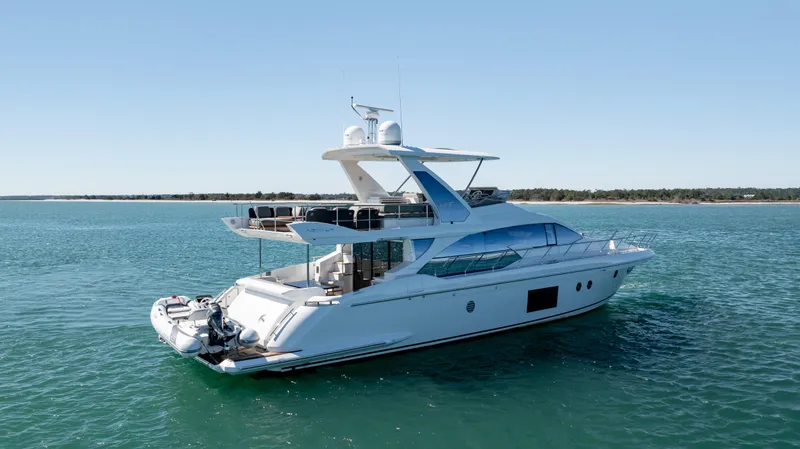  Yacht Photos Pics Luxury 2019 Azimut 66 FLY yacht cruising on serene blue waters.