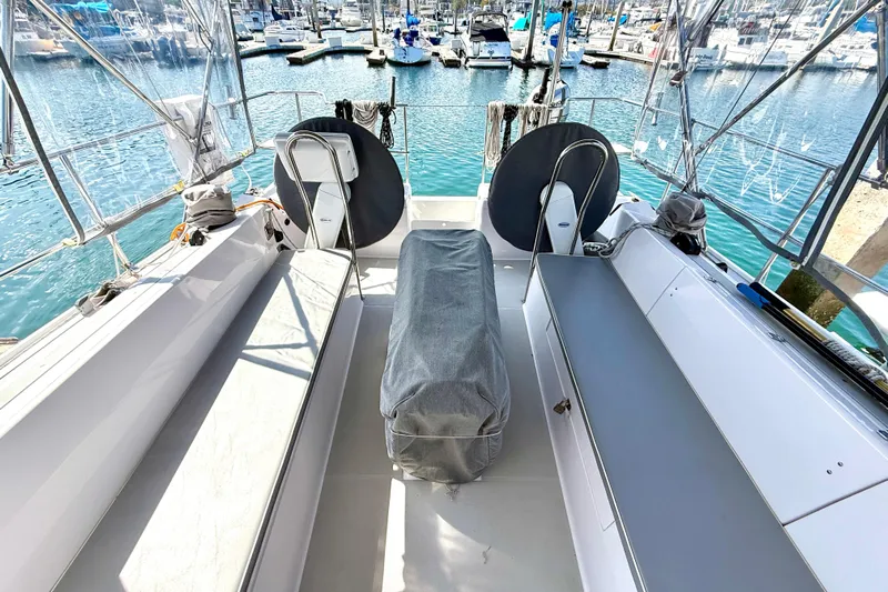 Nereid Yacht Photos Pics 2020 Catalina 425 yacht cockpit with seating, covered equipment, and marina view.