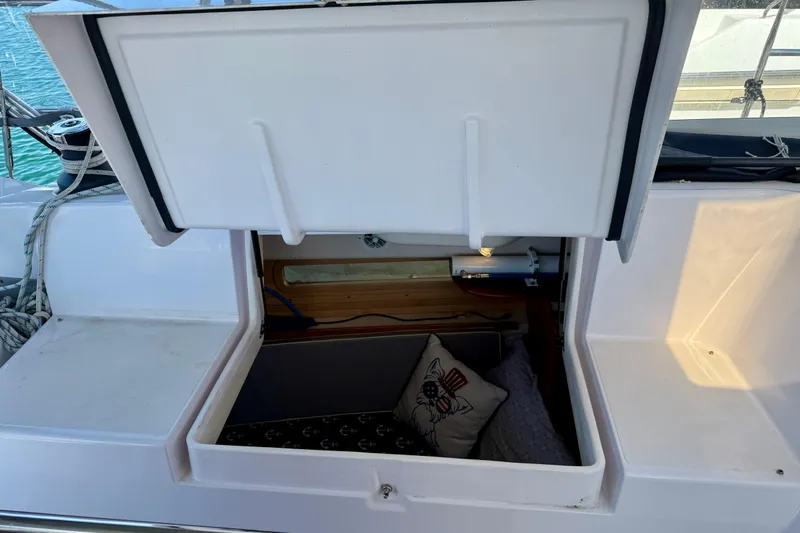 Nereid Yacht Photos Pics Open storage compartment on 2020 Catalina 425 sailboat with nautical-themed pillow inside.
