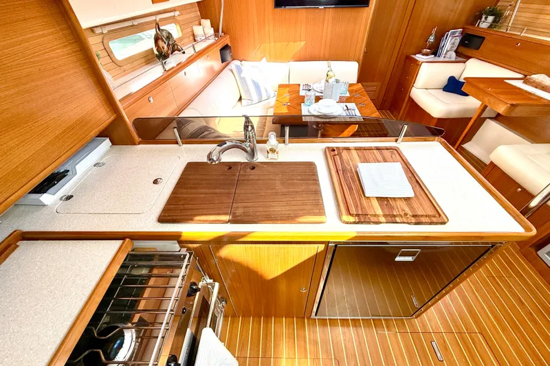 Nereid Yacht Photos Pics Luxurious Catalina 425 yacht interior kitchen with wooden cabinetry and modern amenities, 2020 model.
