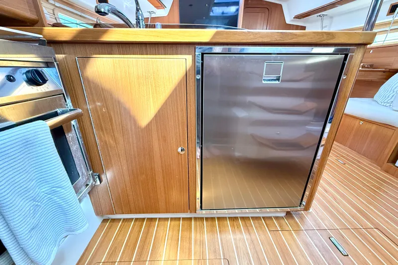 Nereid Yacht Photos Pics Modern kitchen area in 2020 Catalina 425 yacht with wood cabinetry and stainless steel appliances.