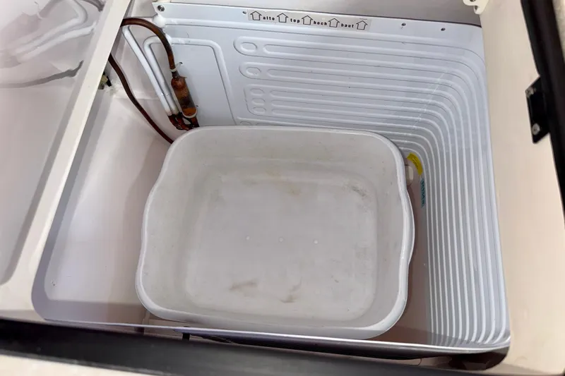 Nereid Yacht Photos Pics Open storage compartment in 2020 Catalina 425 boat with white container inside.