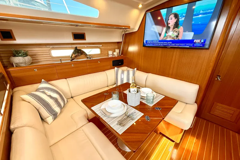 Nereid Yacht Photos Pics Luxurious interior of 2020 Catalina 425 yacht with elegant dining area and TV.
