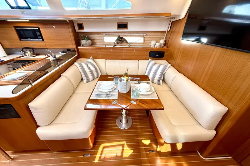 Nereid Yacht Photos Pics Luxurious Catalina 425 yacht interior with elegant dining area, modern kitchen, and cozy seating, 2020 model.