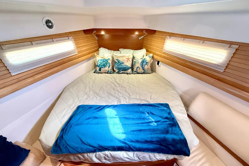 Nereid Yacht Photos Pics Luxurious cabin interior of 2020 Catalina 425 yacht with cozy bedding and nautical decor.