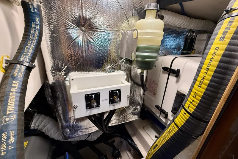 Nereid Yacht Photos Pics Engine compartment of 2020 Catalina 425 sailboat with hoses and control panel.